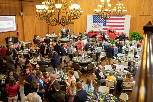 Guests seated at tables under chandeliers during a Republican Party of Benton County dinner