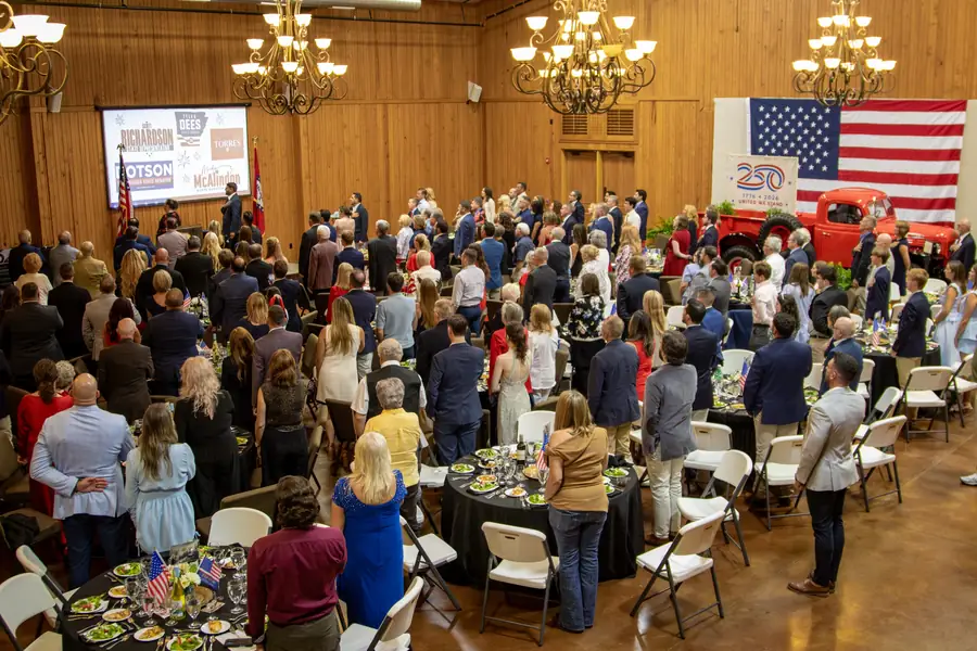 A full room of Benton County Republicans standing for the Pledge of Allegiance at the Legacy of Liberty dinner