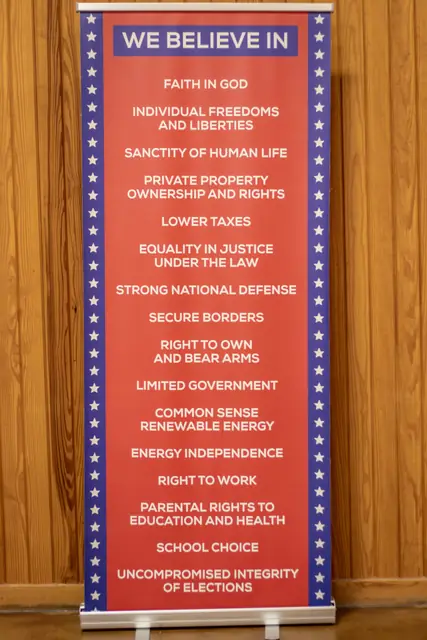 A banner listing the party's stated principles, including faith in God, individual freedoms, limited government, and uncompromised integrity of elections